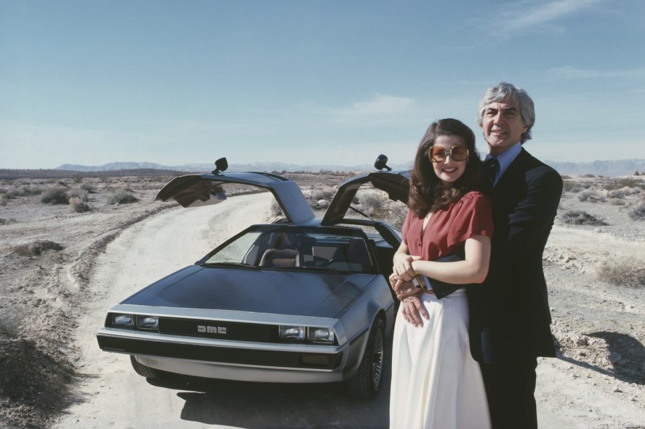 John DeLorean and his wife pose for a photo with his sports car.