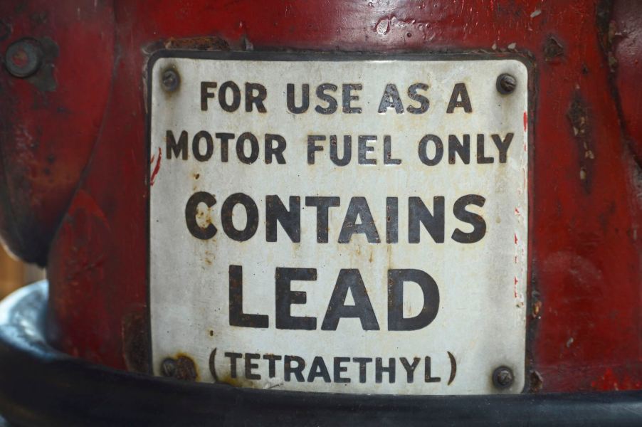 White "contains lead" label on a red gas canister.