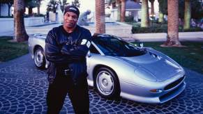 Boxer Mike Tyson with a silver Jaguar XJ220, one of the ultimate 90s cars.