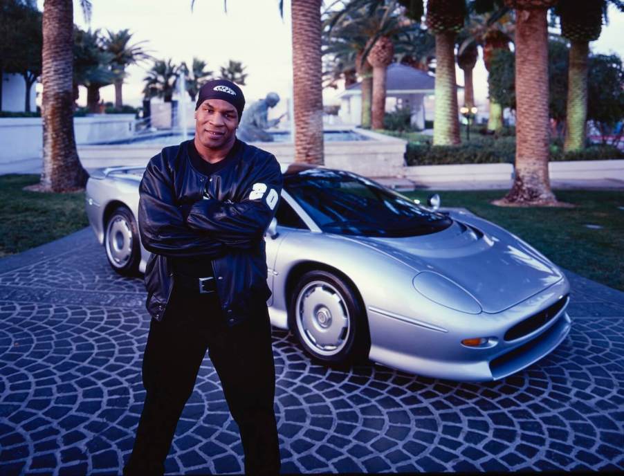 Boxer Mike Tyson with a silver Jaguar XJ220, one of the ultimate 90s cars.