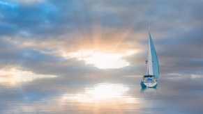 Sailboat completing a whole body burial at sea.