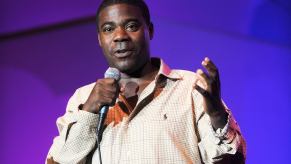 Tracy Morgan holds a microphone on stage.