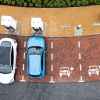 Electric vehicles charging at a charging station, with two EVs parked and charging while two spots remain empty