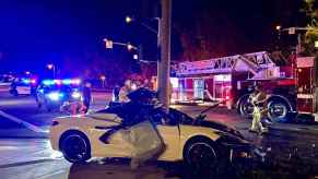 A wrecked white Corvette C8 traffic pole split the car