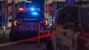 A police inceptor at night with its lights on