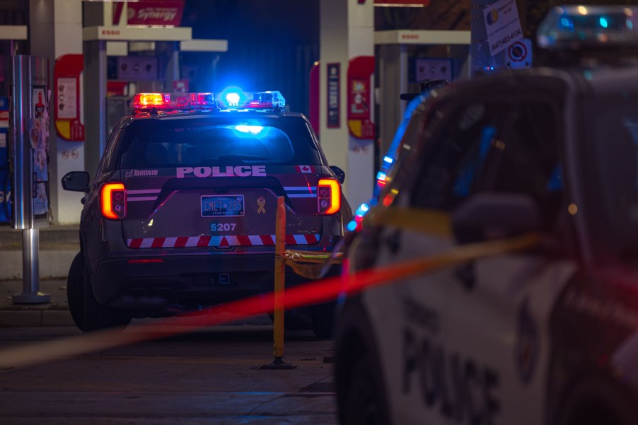 A police inceptor at night with its lights on