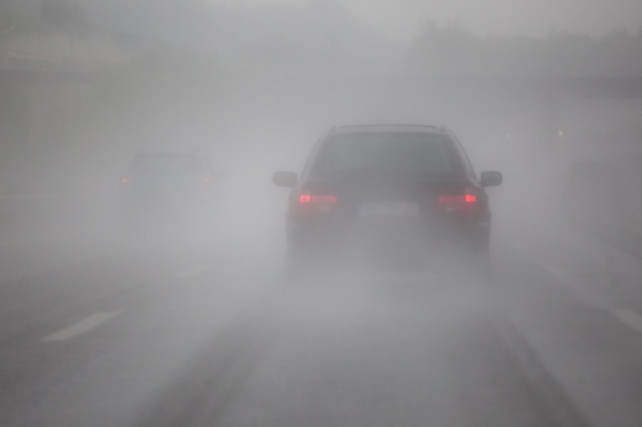 A car driving in fog on the highway