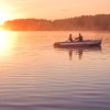 A couple in a rowboat at dusk