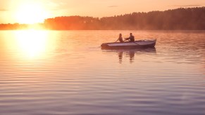 A couple in a rowboat at dusk