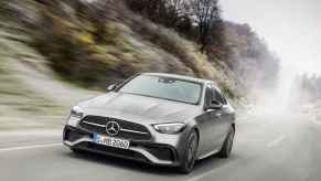 A grey Mercedes-Benz C300 driving on a paved road