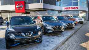 A Nissan dealership with cars on display for cuistomers