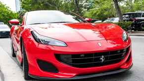 A red Ferrari Portofino parked on a suburban Miami, Florida street