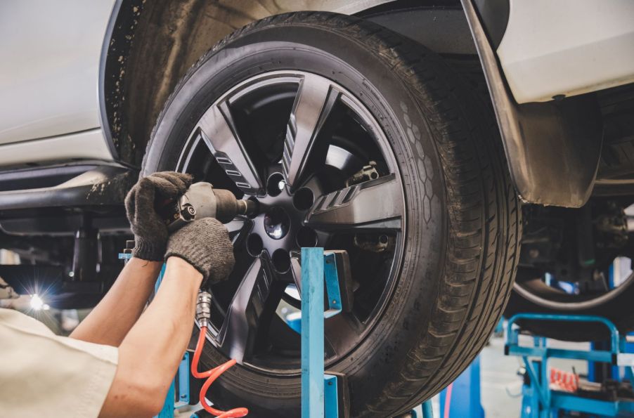 A mechanic fixing a customer's tires