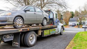 A car on the back of a tow truck