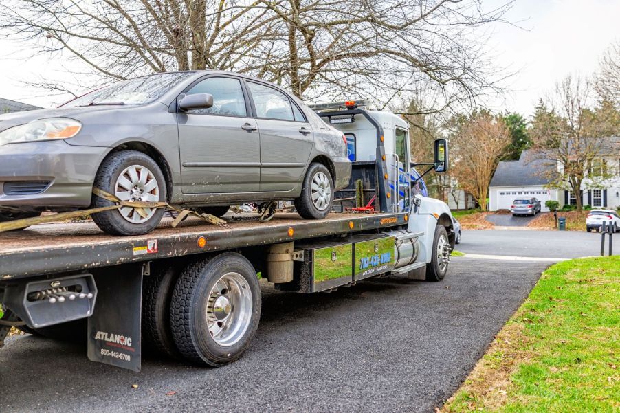 A car on the back of a tow truck