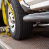 A flatbed tow truck carrying a secured car