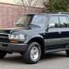 A black 1995 Toyota Land Cruiser parked in left front angle view