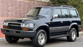 A black 1995 Toyota Land Cruiser parked in left front angle view