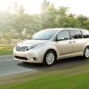 A gold 2017 Toyota Sienna driving