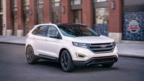 A white 2018 Ford Edge parked in right front angle view