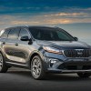 A dark colored 2019 Kia Sorento parked in right front angle view at dusk