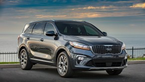 A dark colored 2019 Kia Sorento parked in right front angle view at dusk