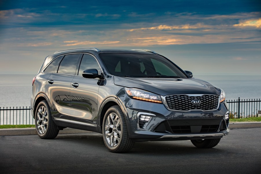 A dark colored 2019 Kia Sorento parked in right front angle view at dusk