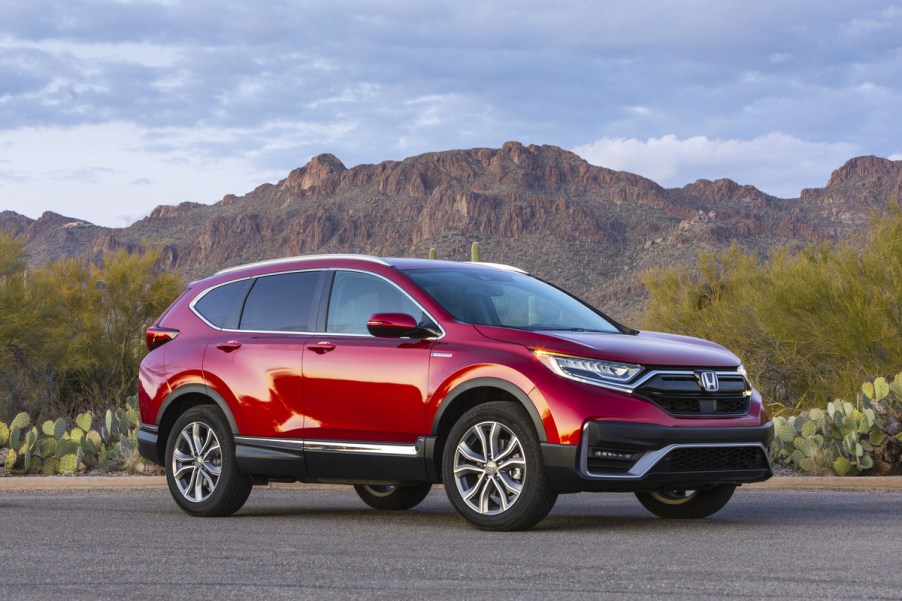 A red 2020 Honda CR-V Hybrid parked in right front angle view in front of a mountain