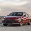 A red 2021 Hyundai Elantra parked on a natruesque highway at dawn