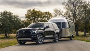 A dark colored 2023 Toyota Sequoia towing an Airstream trailer