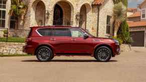 A red 2024 Nissan Armada parked in full right profile view the vehicle is considered one of the fastest-depreciating SUVs in the U.S. market in 2025