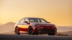 A red 2025 Toyota Camry parked in right front angle view during sunset