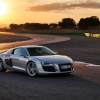 An Audi R8 supercar at track during a sunset.