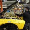 A worker builds American muscle cars like the Dodge Challenger at the Brampton Assembly Plant in Canada.