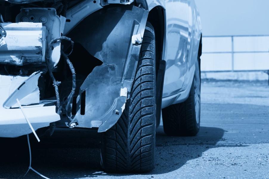 Silver bumper smashed up after a car crash.