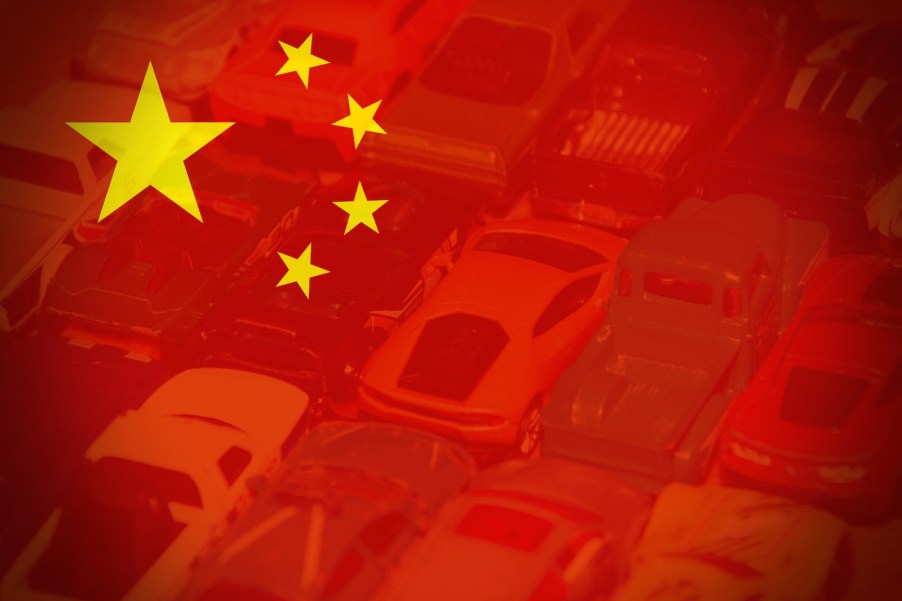 Chinese flag imposed over a car lot.