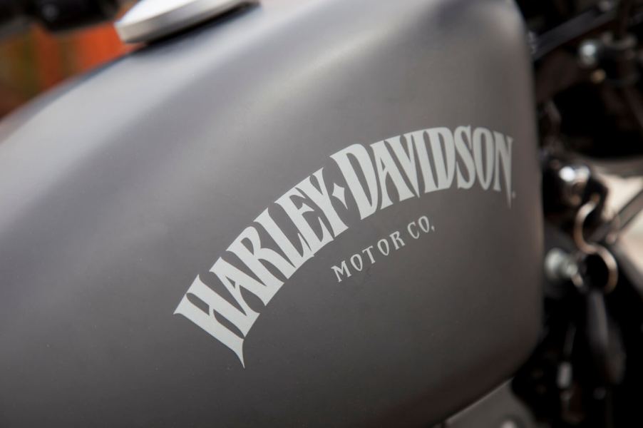 A Harley-Davidson emblem on a gas tank with "Motor Co." or "MoCo" on the paint.