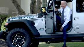 President Joe Biden getting out of a Jeep Wrangler Rubicon 4xe SUV after driving around the White House lawn