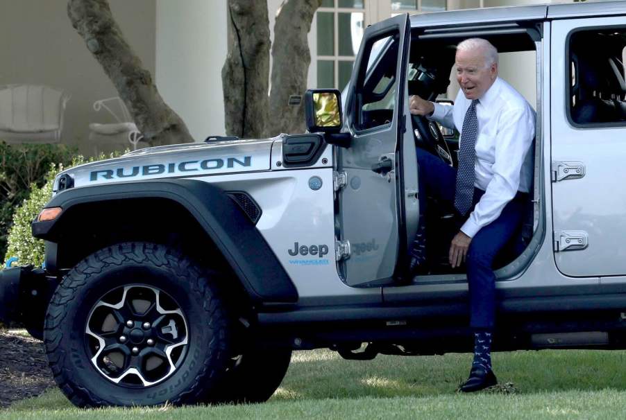 President Joe Biden getting out of a Jeep Wrangler Rubicon 4xe SUV after driving around the White House lawn