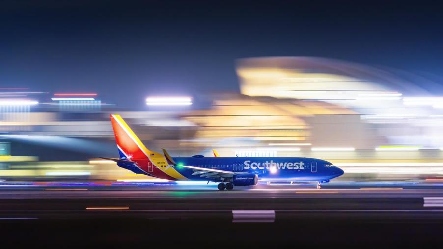 A Southwest Airlines flight takes off at night.