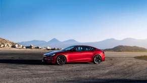 A red Tesla Model S with self-driving functions on a skidpad.