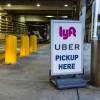 Sign with Uber and Lyft logo at airport marking the ride share driver pickup zone.