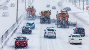 Drivers battle a winter storm on a highway.