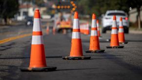 A work site where workers are repairing potholes.