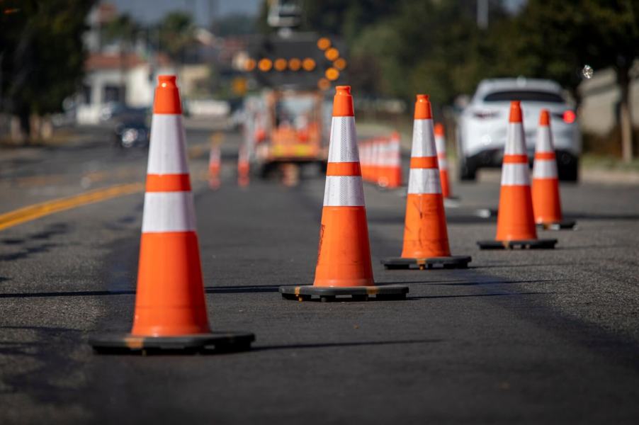 A work site where workers are repairing potholes.