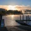 Boat ramp at a lake in the evening with fog settling in the evergreen trees across the water