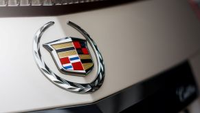 Cadillac emblem on an off-white car