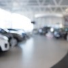 Car dealership sales floor blurred