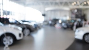 Car dealership sales floor blurred