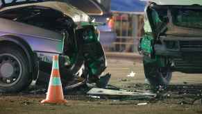 two cars in a car accident looking like it's in the middle of an intersection